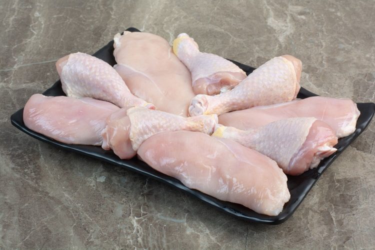 fresh-unprepared-chicken-legs-dark-plate-high-quality-photo