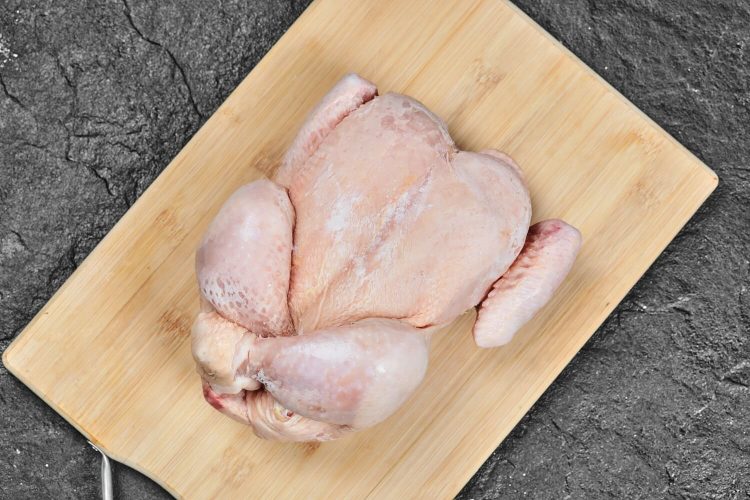 slaughtered chicken on a chopping board